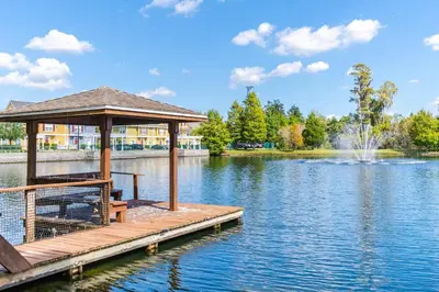 a wooden dock with a gazebo on a lake at Your home 5 * near Disney in Kissimmee