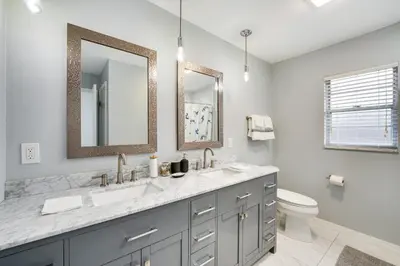 a bathroom with two sinks and a toilet at 7 Mi to Disney World Orlando Home with Private Pool in Orlando