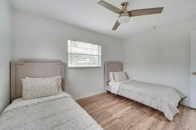 a bedroom with two beds and a ceiling fan at 7 Mi to Disney World Orlando Home with Private Pool in Orlando
