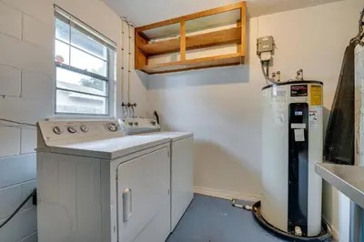 a small kitchen with a sink and a dishwasher at 7 Mi to Disney World Orlando Home with Private Pool in Orlando