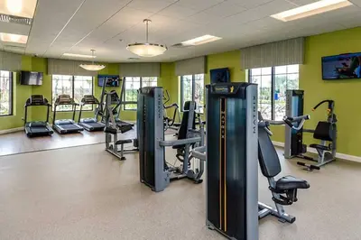 a gym with treadmills and cardio equipment in a room at Lovely Family Home - 10min to Disney - STL107 in Kissimmee