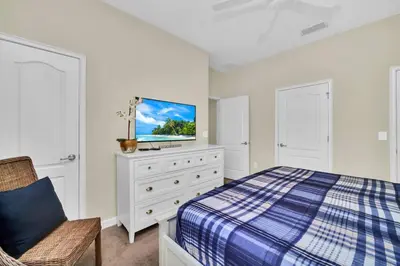 a bedroom with a bed and a tv on a dresser at Lovely Family Home - 10min to Disney - STL107 in Kissimmee