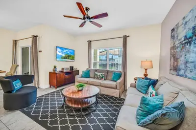 a living room with a couch and a table at Lovely Family Home - 10min to Disney - STL107 in Kissimmee