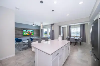 a kitchen and living room with a white counter top at 3131-102JJ STOREY LAKE, CONDO 2/2 LAKE VIEW in Kissimmee