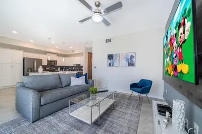 a living room with a couch and a flat screen tv at 3131-102JJ STOREY LAKE, CONDO 2/2 LAKE VIEW in Kissimmee