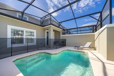a swimming pool in a house with a glass ceiling at 4301WB TOWNHOUSE 5 BEDROOMS & 4 BATHROOMS + POOL in Kissimmee