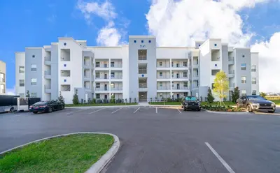 a large white building with cars parked in a parking lot at 3141-307DM STOREY LAKE, CONDO 2/2 LAKE VIEW in Kissimmee