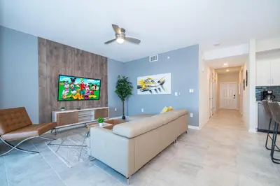 a living room with a couch and a tv at 3141-307DM STOREY LAKE, CONDO 2/2 LAKE VIEW in Kissimmee