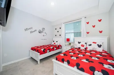 a bedroom with two beds and a window at 3141-204LS STOREY LAKE, CONDO 2/2 LAKE VIEW in Kissimmee