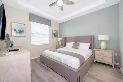 a bedroom with a bed and a ceiling fan at 3131-403AR STOREY LAKE, CONDO 2/2 LAKE VIEW in Kissimmee