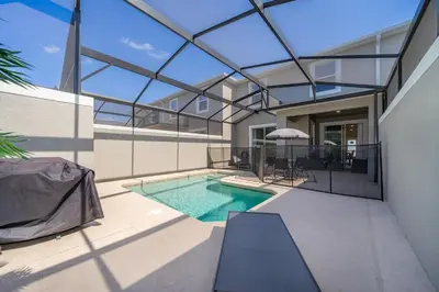 an indoor swimming pool in a house with a glass ceiling at 2921DH TOWNHOUSE 4 BEDROOMS & 3 BATHROOMS + POOL in Kissimmee