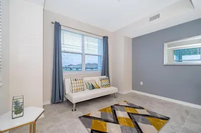 a living room with a couch and a window at 3131-202JQ STOREY LAKE, CONDO 2/2 LAKE VIEW in Kissimmee