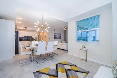 a dining room and kitchen with a table and chairs at 3131-202JQ STOREY LAKE, CONDO 2/2 LAKE VIEW in Kissimmee