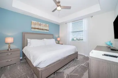 a bedroom with a bed and a ceiling fan at 3131-305RA STOREY LAKE, CONDO 2/2 LAKE VIEW in Kissimmee