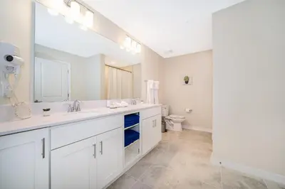 a white bathroom with a sink and a toilet at 3161-308AB STOREY LAKE, CONDO 3/2 LAKE VIEW in Kissimmee