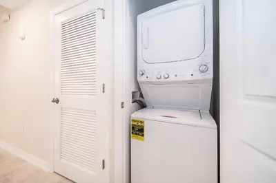 a washer and dryer in a kitchen with a window at 3151-207NC STOREY LAKE, CONDO 2/2 LAKE VIEW in Kissimmee