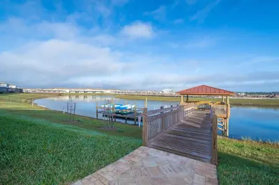 a dock with a gazebo and a boat on a lake at 3151-307BE STOREY LAKE, CONDO 2/2 LAKE VIEW in Kissimmee