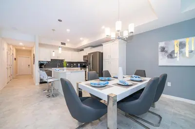 a dining room and kitchen with a table and chairs at 3151-307BE STOREY LAKE, CONDO 2/2 LAKE VIEW in Kissimmee