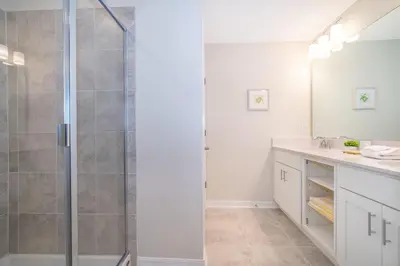 a bathroom with a shower and a sink at 3161-203FC STOREY LAKE, CONDO 2/2 LAKE VIEW in Kissimmee