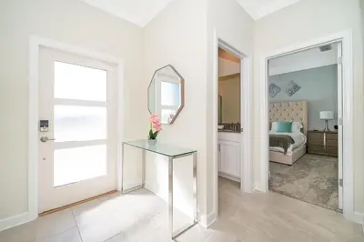 a white room with a mirror and a table at 4381FA TOWNHOUSE 4 BEDROOMS & 3 BATHROOMS + POOL in Kissimmee