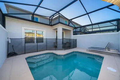 a swimming pool in a house with a glass ceiling at 3005PB TOWNHOUSE 5 BEDROOMS & 4 BATHROOMS + POOL in Kissimmee