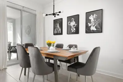 a dining room with a wooden table and chairs at Last Minute Disney Getaway Private Pool Themed Bedrooms. Book Now 56757 in Kissimmee