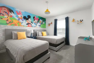 a bedroom with two beds and a painting on the wall at Last Minute Disney Getaway Private Pool Themed Bedrooms. Book Now 56757 in Kissimmee