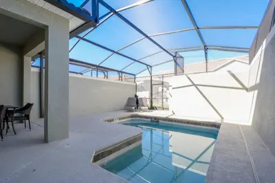 an indoor swimming pool with a glass ceiling at Last Minute Disney Getaway Townhouse with Private Pool. Book Now 17066 in Kissimmee