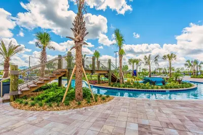 a pool at the resort with a slide and palm trees at Last Minute Disney Getaway Townhouse with Private Pool. Book Now 17066 in Kissimmee