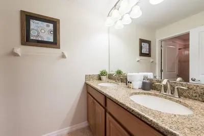 a bathroom with two sinks and a large mirror at Last Minute Disney Getaway! Private Pool, Hot Tub & Games Room. Book Now! #17074 in Kissimmee
