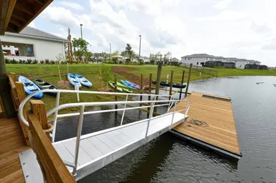 a boat is docked at a dock on a lake at Last Minute Disney Getaway Private Pool Themed Bedrooms. Book Now 17142 in Kissimmee