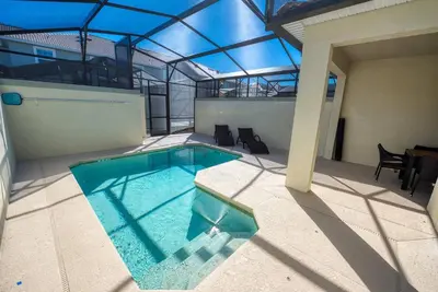 a swimming pool in the middle of a building at Last Minute Disney Getaway Townhouse with Private Pool. Book Now 21174 in Kissimmee