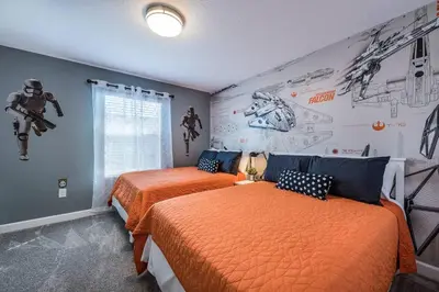 a bedroom with two beds and a superhero mural at Last Minute Disney Getaway Townhouse with Private Pool. Book Now 21174 in Kissimmee