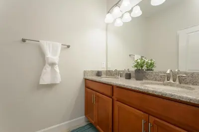 a bathroom with a sink and a mirror at Last Minute Disney Getaway Townhouse with Private Pool. Book Now 17058 in Kissimmee