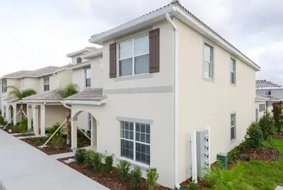 an image of a white house at Last Minute Disney Getaway Townhouse with Private Pool. Book Now 17058 in Kissimmee