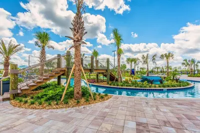 a pool at the resort with a slide and palm trees at Last Minute Disney Getaway Townhouse with Private Pool. Book Now 17058 in Kissimmee