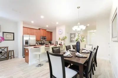 a dining room and kitchen with a table and chairs at Last Minute Disney Getaway Townhouse with Private Pool. Book Now 17058 in Kissimmee