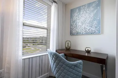 a desk and a chair in a room with a window at Last Minute Disney Private Pool Hot Tub Game Room Themed Bedrooms. Book Now 29466 in Kissimmee