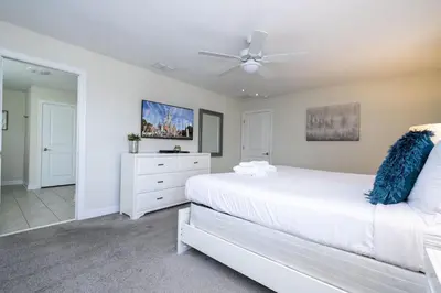 a bedroom with a white bed and a ceiling fan at Last Minute Disney Private Pool Hot Tub Game Room Themed Bedrooms. Book Now 29466 in Kissimmee