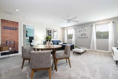 a living room with a table and a couch at Last Minute Disney Private Pool Hot Tub Game Room Themed Bedrooms. Book Now 29466 in Kissimmee