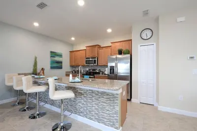 a kitchen with a counter and a refrigerator at Last Minute Disney Getaway! Private Pool, Hot Tub & Games Room. Book Now! #17050 in Kissimmee