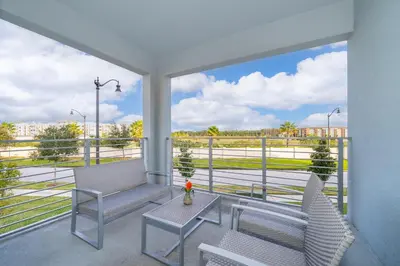 a balcony with two chairs and a table at 4721-201AB STOREY LAKE, CONDO 3/2 GARDEN VIEW in Kissimmee