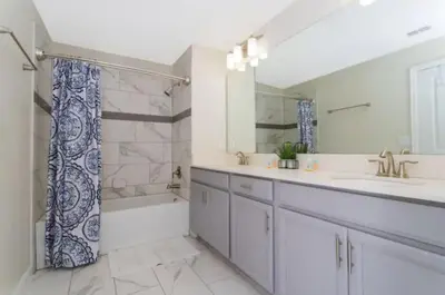 a bathroom with two sinks and a tub and a shower at Roomy Family Home-Sleeps 16 STL110 in Kissimmee