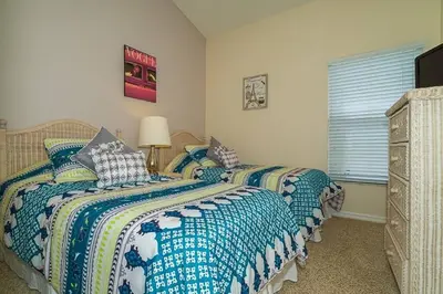 a bedroom with two twin beds and a window at 2025 Vacation Savings Secure Your Spot Today in Orlando