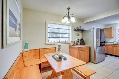 a kitchen with a wooden table and a dining room at Patio and Grill Idyllic Sorrento Vacation Home! in Sorrento