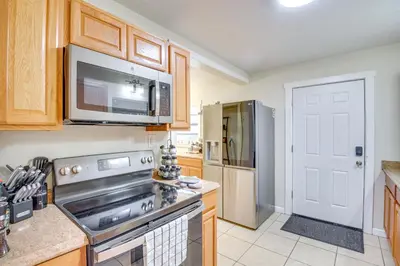 a kitchen with a stove and a microwave at Patio and Grill Idyllic Sorrento Vacation Home! in Sorrento