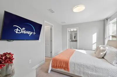 a bedroom with a bed and a sign on the wall at Luxury Villa 5BedroomsPool- 4 miles from Disney in Orlando