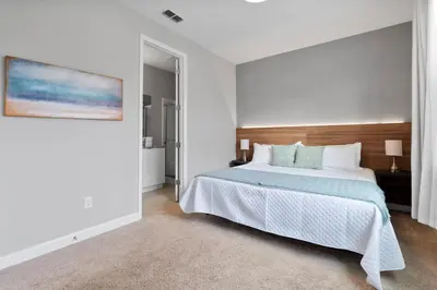 a bedroom with a bed and a painting on the wall at Luxury Villa 5BedroomsPool- 4 miles from Disney in Orlando