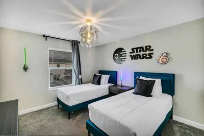 a hotel room with two beds and a chandelier at Stylish Family Home - Private Pool - STL111 in Kissimmee