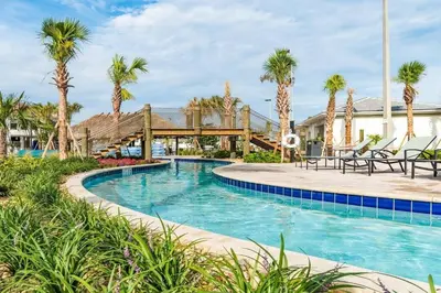 a swimming pool at a resort with palm trees at Really close to Disney! Sleeps 10 - STL116 in Kissimmee